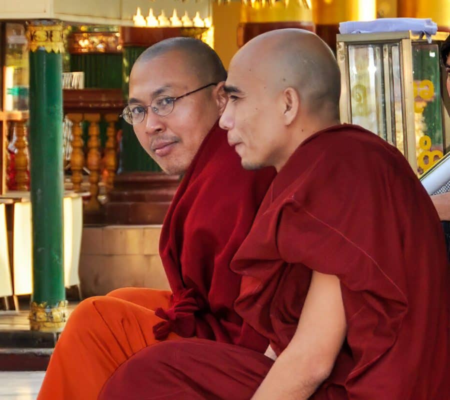 two monks seated at pagoda